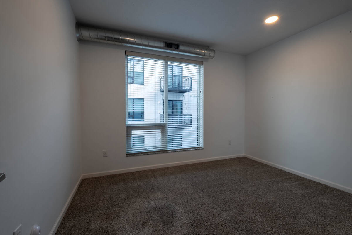 Apartment interior with large window and neutral walls in Minneapolis, MN.