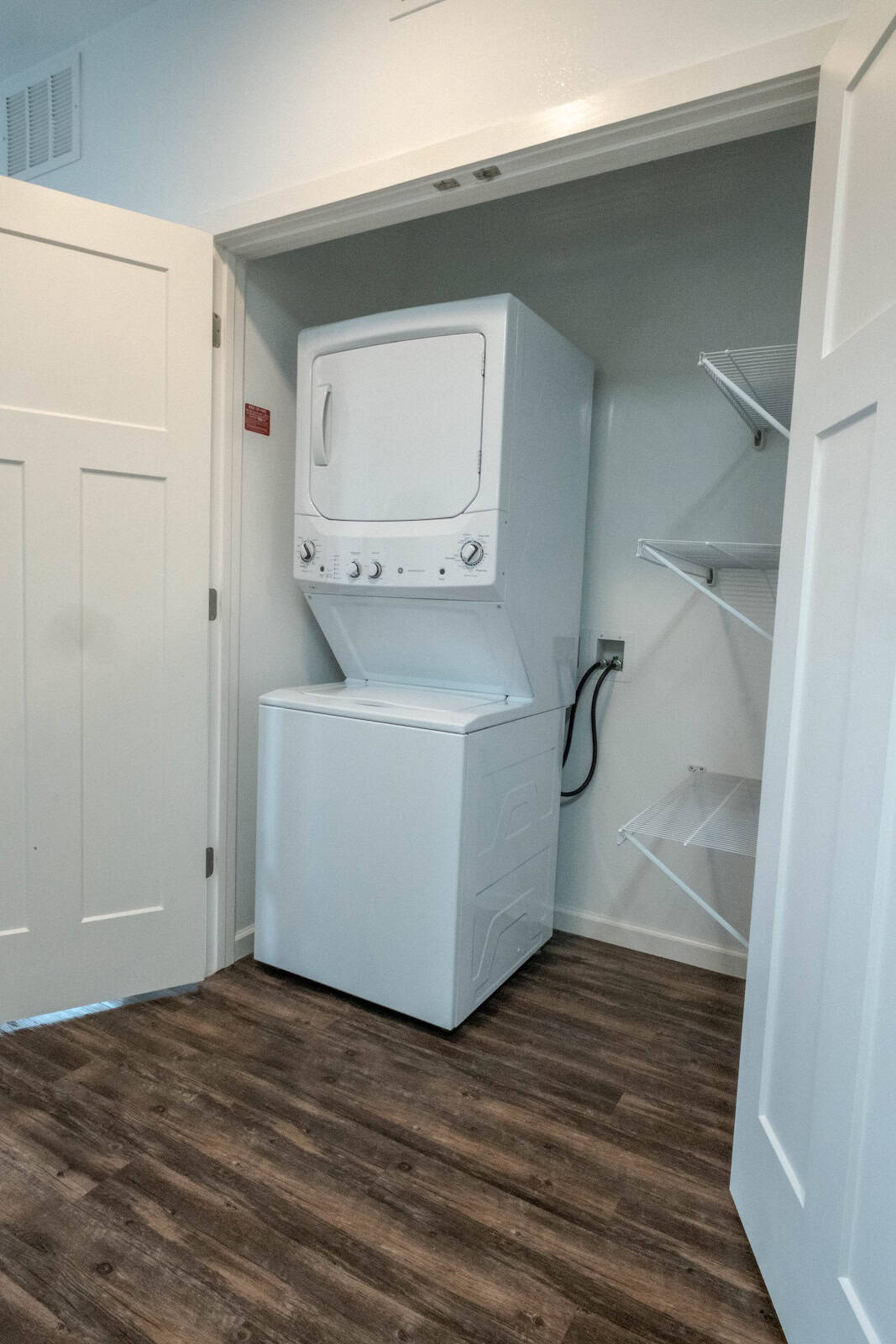 Stacked washer and dryer in a small laundry closet at The Pearl Apartments, Minneapolis, MN.