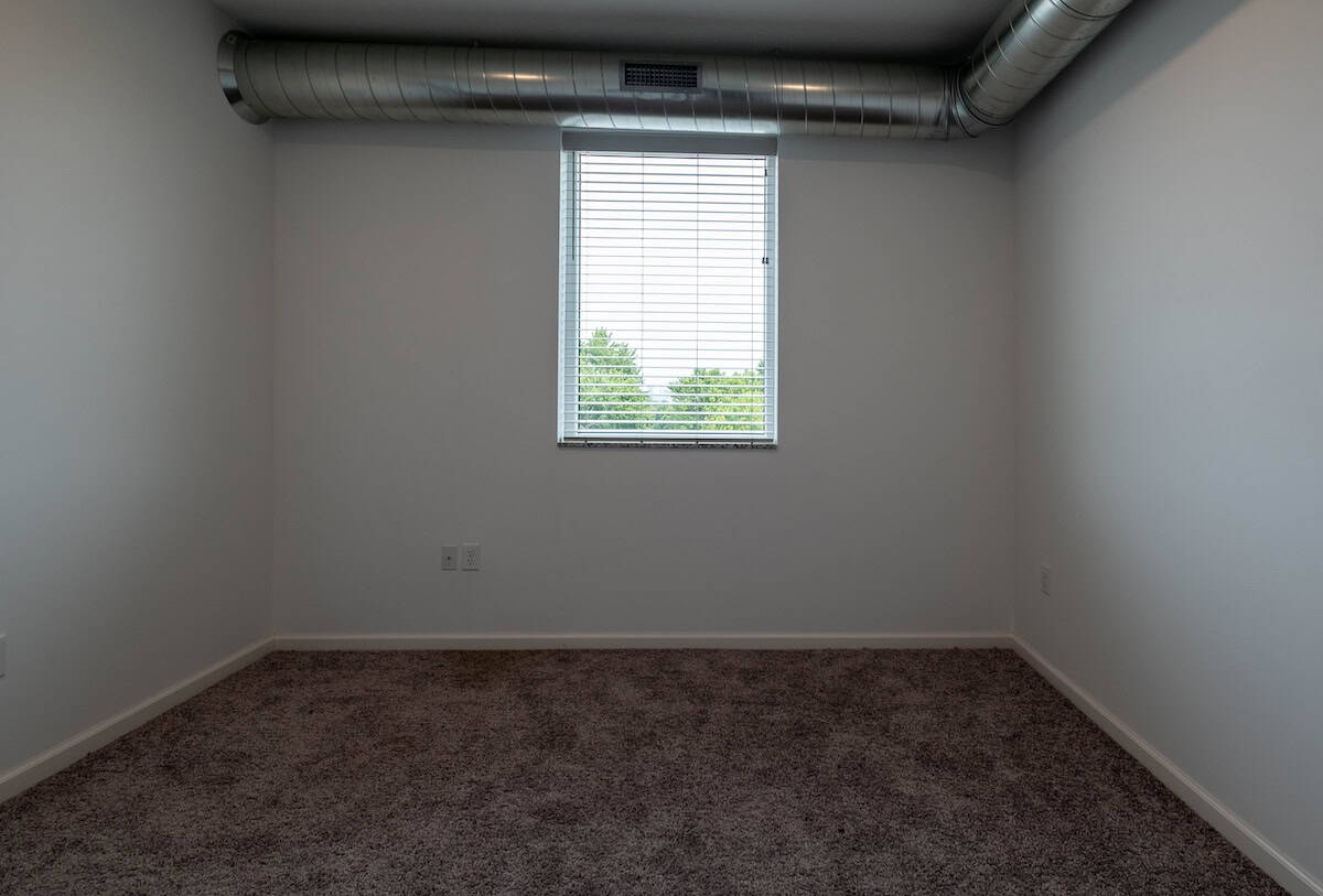 Empty room with window and natural light at The Pearl Apartments, Minneapolis, MN.
