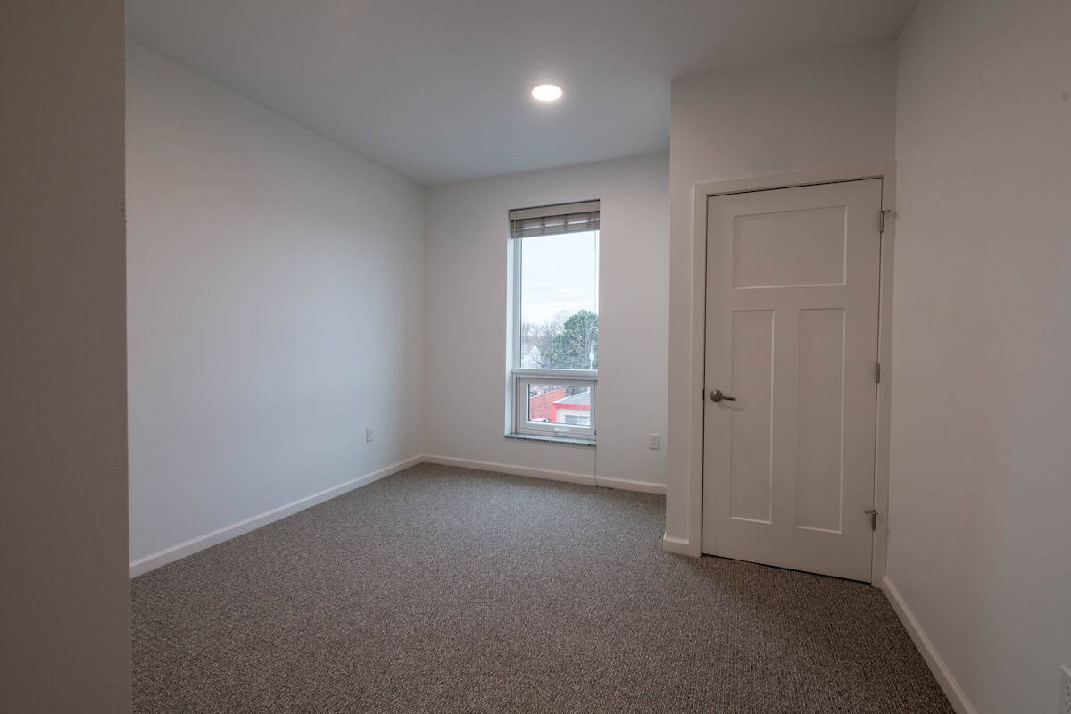 Modern empty room with window and door at The Pearl Apartments, Minneapolis, MN.